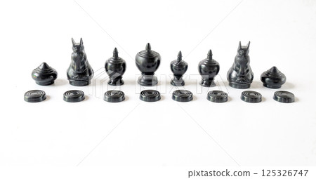 Asian black chess figurines over a white background.Asian gaming. 125326747