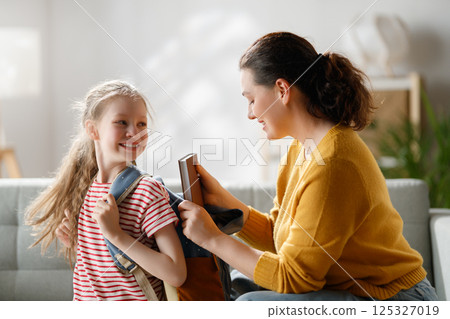 Happy family preparing for school 125327019