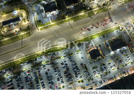 Traffic rush at shopping malls and small businesses in evening time in North Port, Florida. USA transportation and retail infrastructure concept Traffic rush at shopping malls and small businesses in evening time in North Port, Florida. USA transportation and retail infrastructure concept 125327058