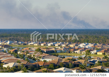 Toxic smoke from prescribed forest fire rising up over suburban neighborhood in Florida polluting air Toxic smoke from prescribed forest fire rising up over suburban neighborhood in Florida polluting air 125327084
