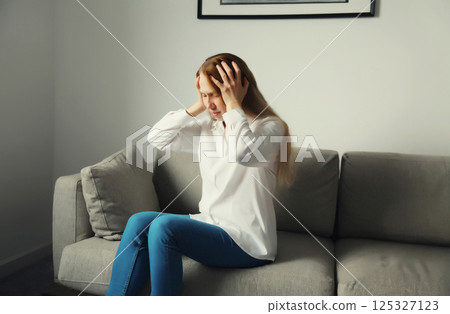 Exhausted tired woman suffering from headache, stress, fatigue, temples pain, migraine, loud noise 125327123