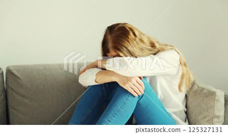 Upset sad crying woman while experiencing mental suffering, depression, fatigue, emotional stress Upset sad crying woman while experiencing mental suffering, depression, fatigue, emotional stress 125327131