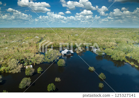 Surrounded by hurricane Ian rainfall flood waters homes in Florida residential area. Aftermath of natural disaster Surrounded by hurricane Ian rainfall flood waters homes in Florida residential area. Aftermath of natural disaster 125327141