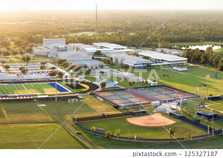 Sports facilities at public school in North Port, Florida. American football stadium, tennis court and baseball diamond sport infrastructure 125327187