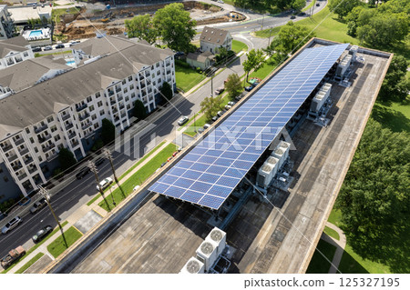Solar roof on condominium building in Nashville, Tennessee. Photovoltaic panels for producing of clean ecological electrical energy in city urban area. Concept of autonomous building 125327195