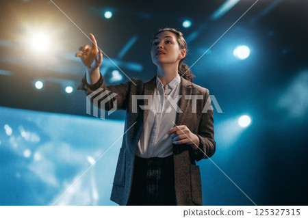 A woman is speaking on stage 125327315