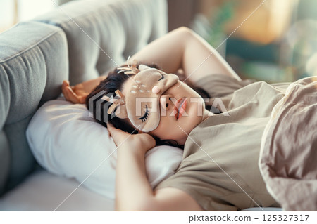 woman is sleeping in the bedroom 125327317