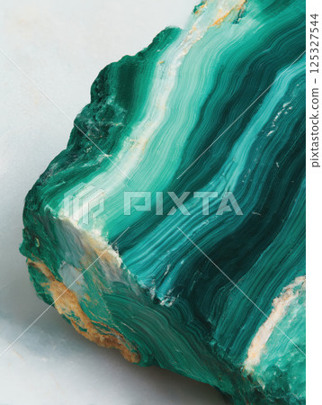 Macro close-up of single piece of malachite gemstone with layered green rings and smooth texture. Studio mineral photography. Geology and decorative stone concept. Design for print, wallpaper, banner. Macro close-up of single piece of malachite gemstone with layered green rings and smooth texture. Studio mineral photography. Geology and decorative stone concept. Design for print, wallpaper, banner. 125327544