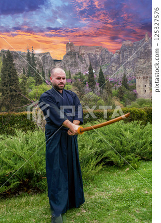 Kendo fighter with wooden sword on awe background Kendo fighter with wooden sword on awe background 125327576