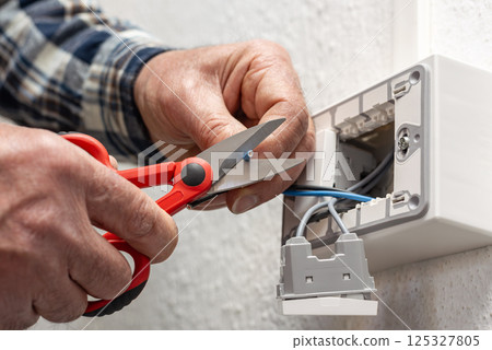 Electrician at work on a residential electrical system. Electricity. 125327805