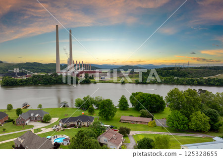 Residential neighborhood close to thermal power plant in Roane County near Kingston, Tennessee. Coal fossil fuel causing environmental pollution during electric energy production in American grid Residential neighborhood close to thermal power plant in Roane County near Kingston, Tennessee. Coal fossil fuel causing environmental pollution during electric energy production in American grid 125328655