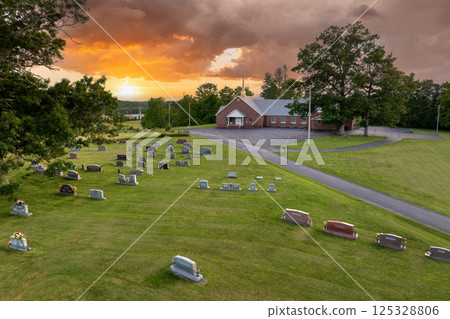 Old American cemetery with rows of tombstones on country church graveyard Old American cemetery with rows of tombstones on country church graveyard 125328806