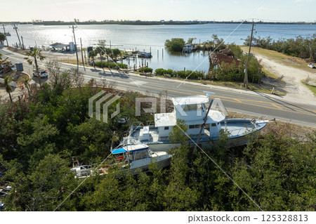 Natural disaster consequences. Destroyed sailboats after hurricane in Florida Natural disaster consequences. Destroyed sailboats after hurricane in Florida 125328813