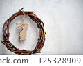 the easter wreath from branches vines with thread on grey background with copyspace. 125328909