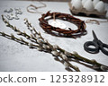 the easter wreath from branches vines with thread on grey background with copyspace. DIY decoration with eggs 125328912