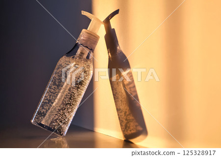 A tube of cosmetic gel or shower gel in the rays of the setting sun. 125328917