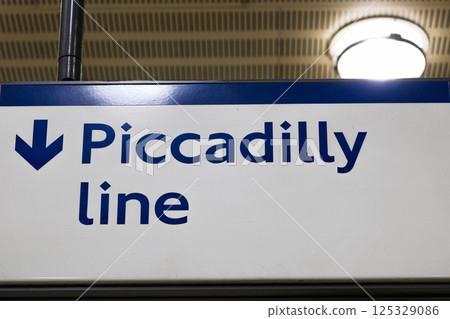 Clear Piccadilly Line Sign with Downward Arrow in London Underground Station Clear Piccadilly Line Sign with Downward Arrow in London Underground Station 125329086