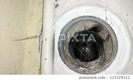 Ventilation hole revealing inner structure of wall in residential building 125329112