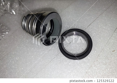 Mechanical pump seal components displayed on a clean surface ready for installation and inspection 125329122