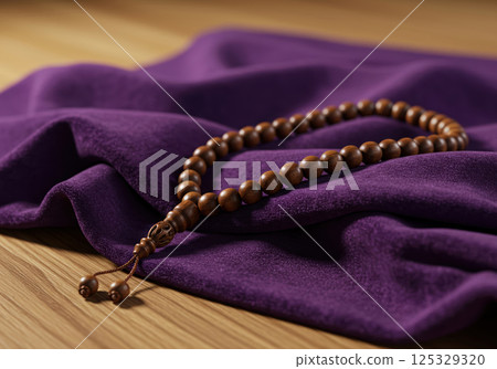 Wooden prayer beads placed on purple cloth (AI-generated image) 125329320