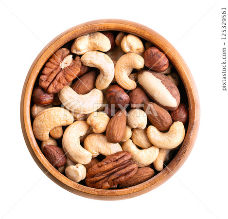 Roasted fancy nut mix, snack food in a wooden bowl. Roasted cashews, combined with almonds, hazelnuts, Brazil nuts, and pecan nuts. Blend of nuts, a good source of protein, fiber and unsaturated fats. 125329561