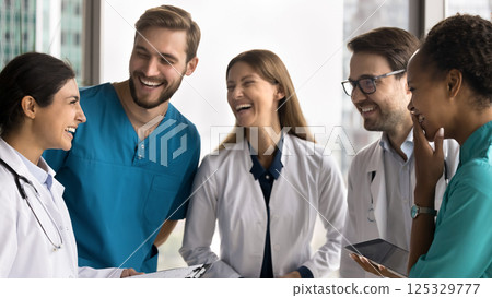 Friendly diverse multiethnic doctors laughing in group at hospital workplace 125329777