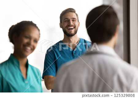 Laughing young man surgeon having fun relax with doctors team Laughing young man surgeon having fun relax with doctors team 125329808