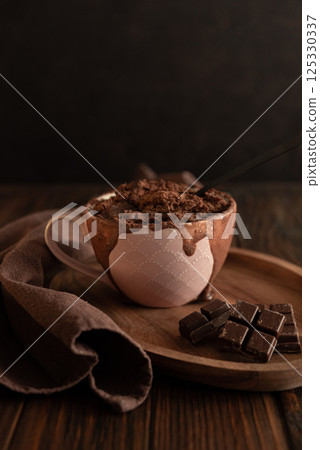 Chocolate mug cake on dark wooden table.Easy homemade dessert. Mugcake from microwave 125330337