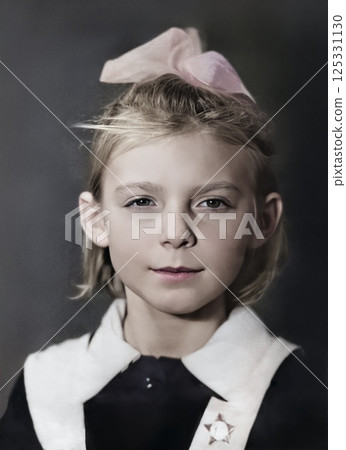 Vintage portrait of a girl in a school uniform from the USSR and a bow on her head. Retro photo from 1968. 125331130