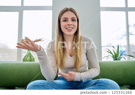 Web cam view of young woman talking looking in camera, online meeting, video call Web cam view of young woman talking looking in camera, online meeting, video call 125331168