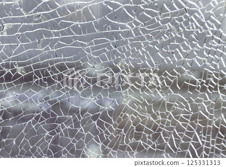 Texture of cracked broken glass cracked by impact. Texture of cracked broken glass cracked by impact. 125331313