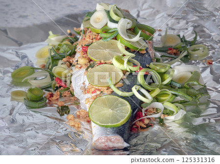 Prepare Whole Baked Salmon with Herbs on aluminium foil. 125331316
