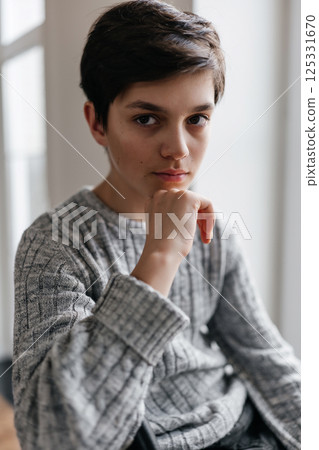 portrait of a pretty teenager sitting on the chair indoors portrait of a pretty teenager sitting on the chair indoors 125331670