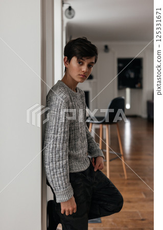 portrait of handsome teenager standing near the wall portrait of handsome teenager standing near the wall 125331671