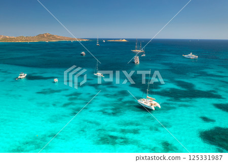 Aerial view of luxury yachts and boats on blue sea, island Aerial view of luxury yachts and boats on blue sea, island 125331987