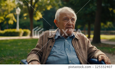 Young man having fun with his father on wheelchair at park 125332407
