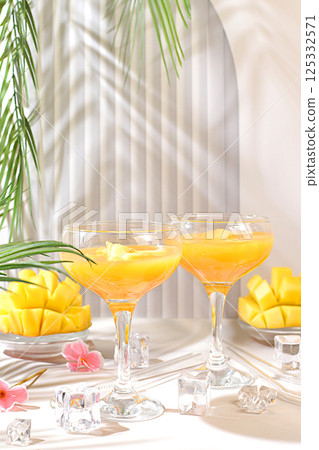 Frozen lemonade cocktail, margarita with mango slices, tequila, vodka, ice, bar and party concept, restaurant and cafe advertising card, top view, selective focus. 125332571