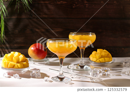 Summer party concept. Frozen lemonade cocktail, margarita with mango slices, tequila, vodka, ice, bar and leisure concept, restaurant and cafe advertising card, top view, 125332579