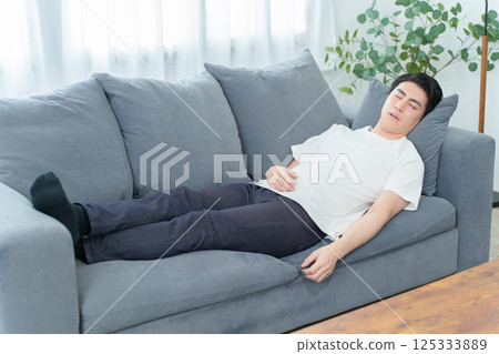 Man taking a nap on the sofa 125333889