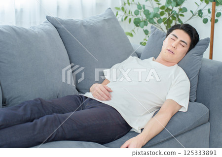 Man taking a nap on the sofa 125333891