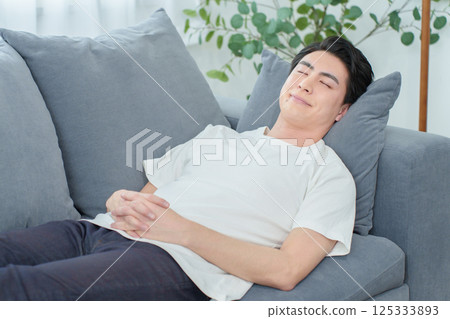 Man taking a nap on the sofa Man taking a nap on the sofa 125333893