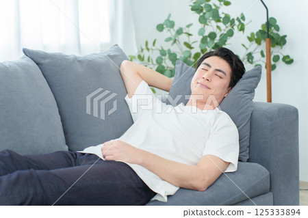Man taking a nap on the sofa Man taking a nap on the sofa 125333894