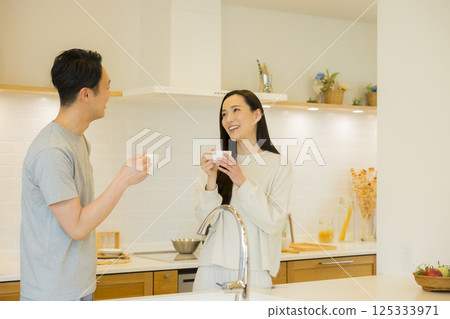 A couple standing in the kitchen A couple standing in the kitchen 125333971