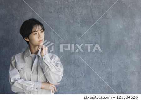 A smiling woman in work clothes A smiling woman in work clothes 125334520