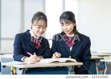 High school girls studying. Photo courtesy of Denpa Gakuen, Tokyo Electronics College. 125335992