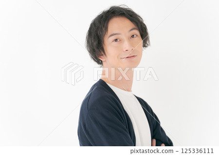 A man in his 30s standing with his arms folded A man in his 30s standing with his arms folded 125336111