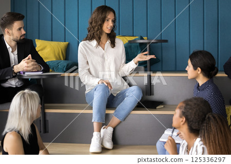 Young woman student speak to diverse classmates at multilevel classroom 125336297
