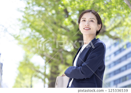 Business: Portrait of a woman walking through an office district 125336539