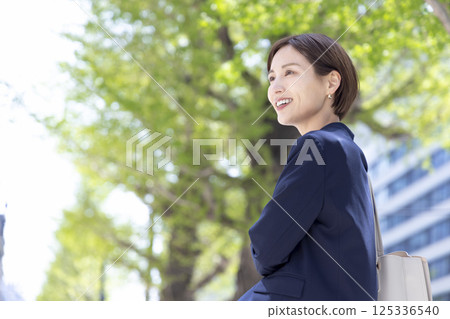Business: Portrait of a woman walking through an office district 125336540