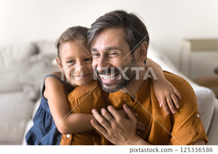 Portrait affectionate preteen daughter hug beloved mature dad from back Portrait affectionate preteen daughter hug beloved mature dad from back 125336586